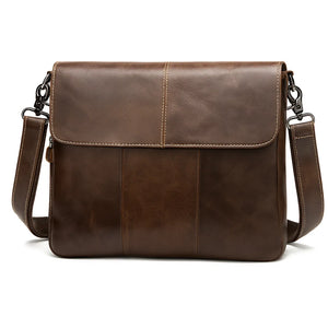 Archer unisex oil-wax leather crossbody messenger in coffee brown, worn across the body on a city street