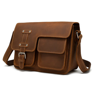 Men’s brown leather business messenger bag (first-layer cowhide) with adjustable shoulder strap, sized for a 12-inch laptop.