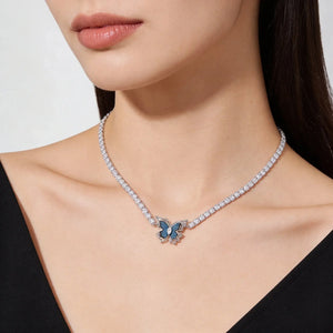 Necklace with a butterfly pendant worn by a model on a white background