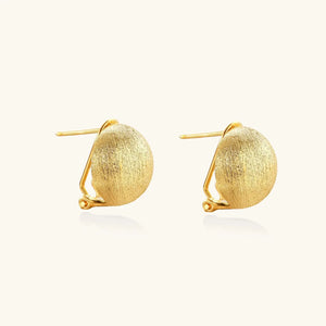 Pair of gold earrings on a white background
