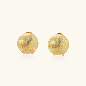 Pair of gold textured round earrings on a white background