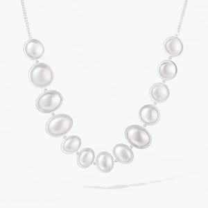 Sterling silver statement necklace with large oval and round pearls on a white background