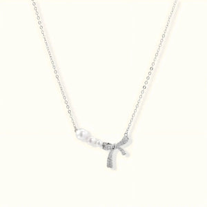 Necklace with a pearl and silver leaf pendant on a white background
