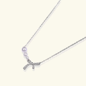 Necklace with a starfish pendant and pearl on a white background
