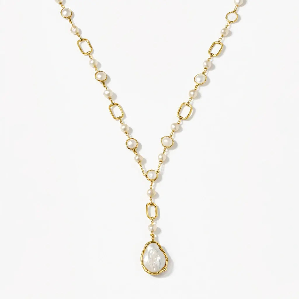 14K gold Y necklace with baroque pearl and oval links on white background