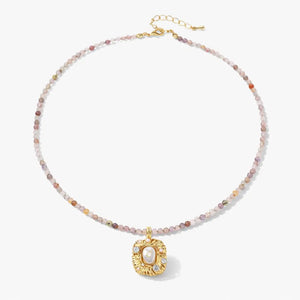 18K gold necklace with pastel gemstone beads and ornate gold pendant with crystals