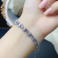 Natural tanzanite bracelet set in S925 sterling silver, ~7-inch adjustable tennis style with lobster clasp, blue-violet gemstones.
