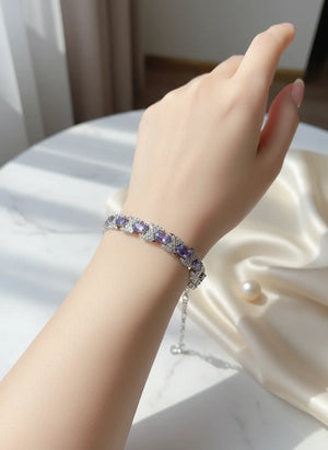 Natural tanzanite bracelet set in S925 sterling silver, ~7-inch adjustable tennis style with lobster clasp, blue-violet gemstones.