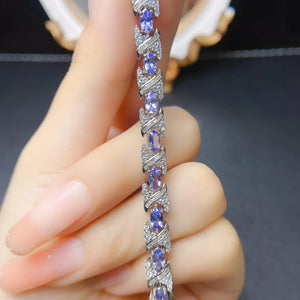 Natural tanzanite bracelet set in S925 sterling silver, ~7-inch adjustable tennis style with lobster clasp, blue-violet gemstones.