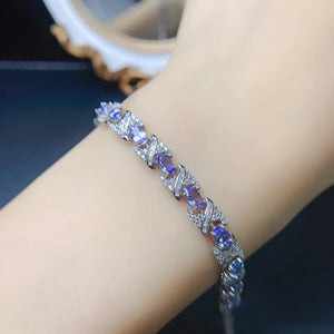 Natural tanzanite bracelet set in S925 sterling silver, ~7-inch adjustable tennis style with lobster clasp, blue-violet gemstones.