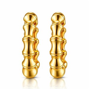 A pair of gold hoop earrings with a textured, segmented design resembling stacked bamboo or beads, shown on a clean white background with a soft reflection below.