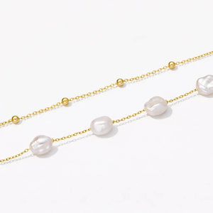 18K gold vermeil layered bracelet with baroque pearls and gold beads on a white background