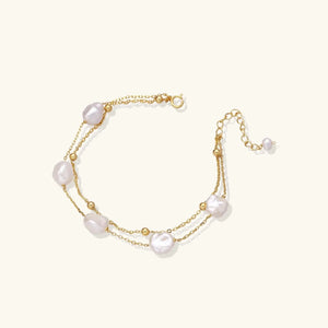 Gold bracelet with pearls on a white background