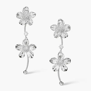 Silver cascade earrings with double flower design and crystal accent on white background