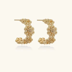 Gold hoop earrings on a white background