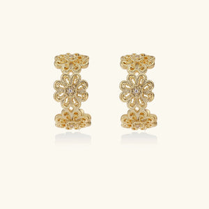 Pair of gold earrings on a white background