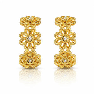A pair of gold filigree earrings with floral motifs and small clear gemstones, displayed on a clean white background with a soft reflection below.