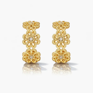 Gold filigree hoop earrings with floral design and sparkling gemstone accents
