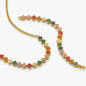 Colorful floral bracelet with gold chain on a white background