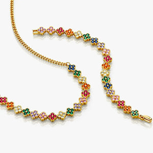 Colorful floral bracelet with gold chain on a white background