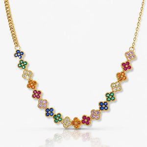 Gold necklace with colorful gemstone flowers on a white background