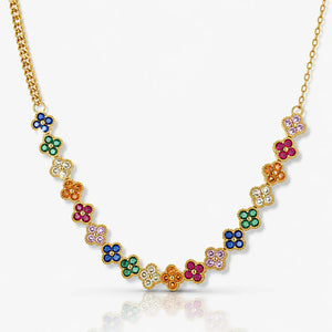 Gold necklace with colorful gemstone flowers on a white background