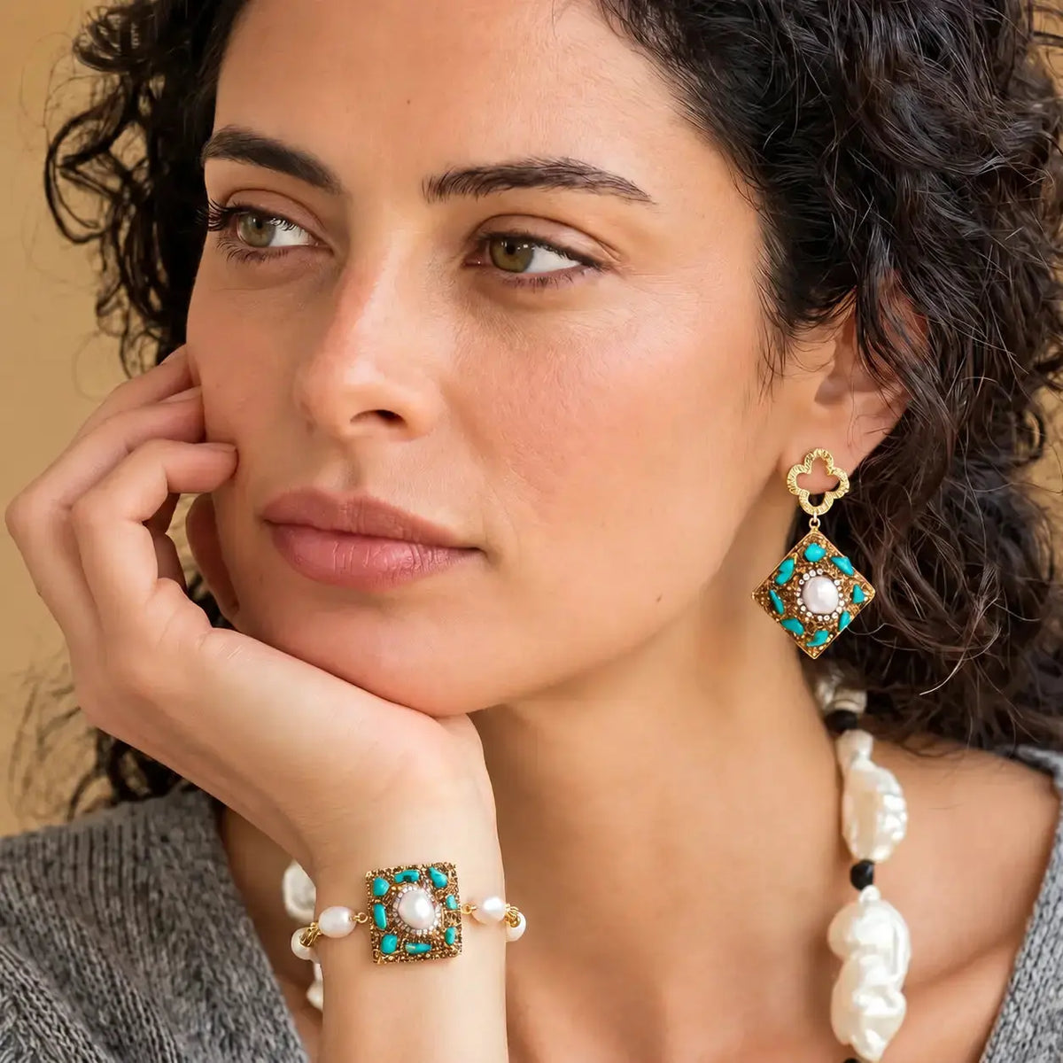 Woman wearing elegant earrings and rings against a natural background