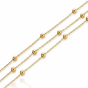 Gold chain necklace with evenly spaced round bead links, shown diagonally on a clean white background.