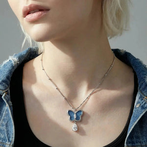 White gold butterfly crystal pendant necklace on model, elegant jewelry style