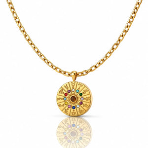 Gold necklace with a circular pendant featuring colorful stones on a white background