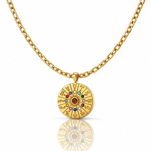Gold necklace with a circular pendant featuring colorful stones on a white background