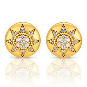 A pair of round gold starburst stud earrings set with clear gemstones, displayed on a clean white background with a soft reflection below.