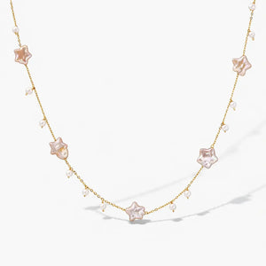 Gold vermeil necklace with star-shaped pearls and small round pearls on a white background