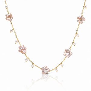 A delicate gold chain necklace featuring five pale pink star-shaped charms and small white pearl beads, displayed on a clean white background with a soft reflection.
