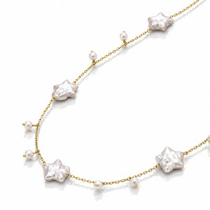 A delicate gold chain necklace featuring irregular white baroque pearls shaped like stars and small round pearls, displayed on a clean white background.