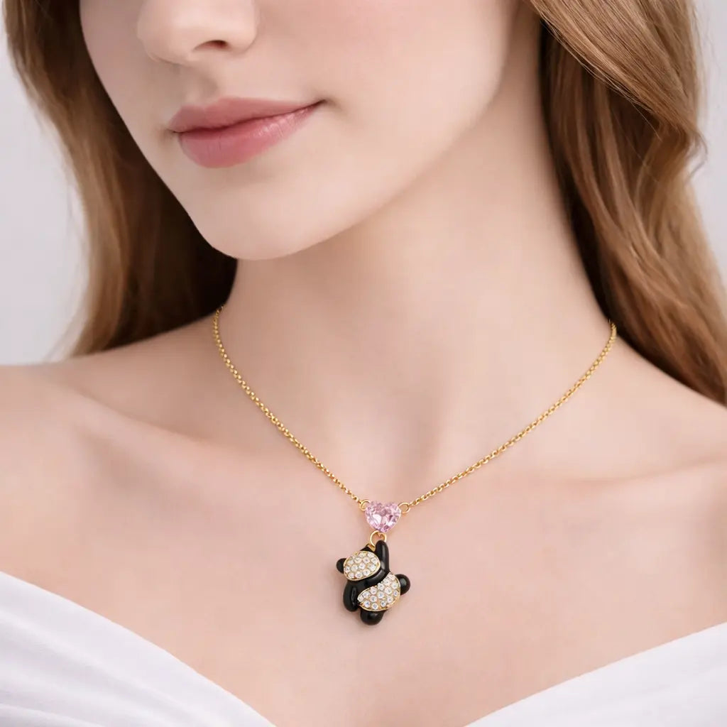 Woman wearing a gold necklace with a panda pendant