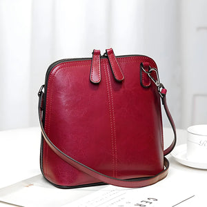 Chic Leather Shell Crossbody bag for women in genuine leather, compact 20cm size with adjustable strap and multiple color options.