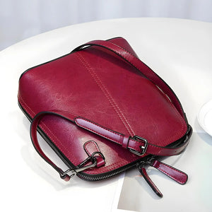 Chic Leather Shell Crossbody bag for women in genuine leather, compact 20cm size with adjustable strap and multiple color options.