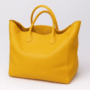 Black genuine leather super tote bag with large capacity, dual handles, and structured square shape – Chic Leather Super Tote.