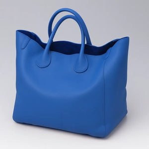 Black genuine leather super tote bag with large capacity, dual handles, and structured square shape – Chic Leather Super Tote.