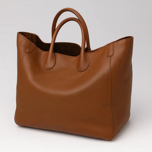 Black genuine leather super tote bag with large capacity, dual handles, and structured square shape – Chic Leather Super Tote.