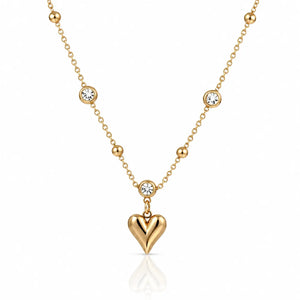 Gold necklace with a heart pendant on a white background