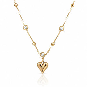 Gold necklace with a heart pendant on a white background