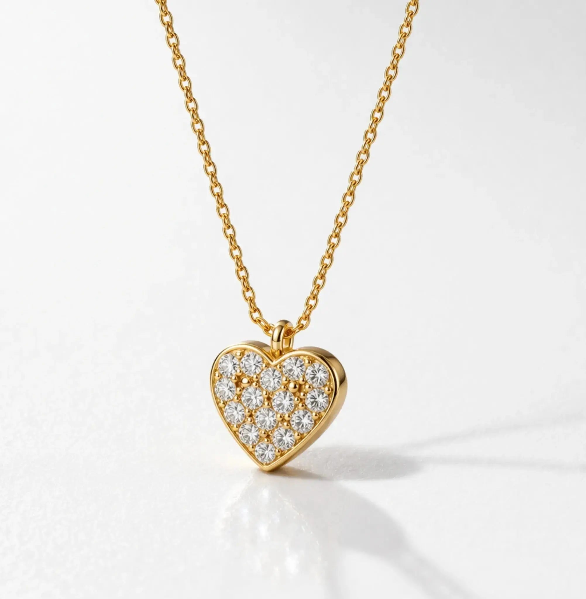 Gold heart-shaped necklace with diamonds on a white background