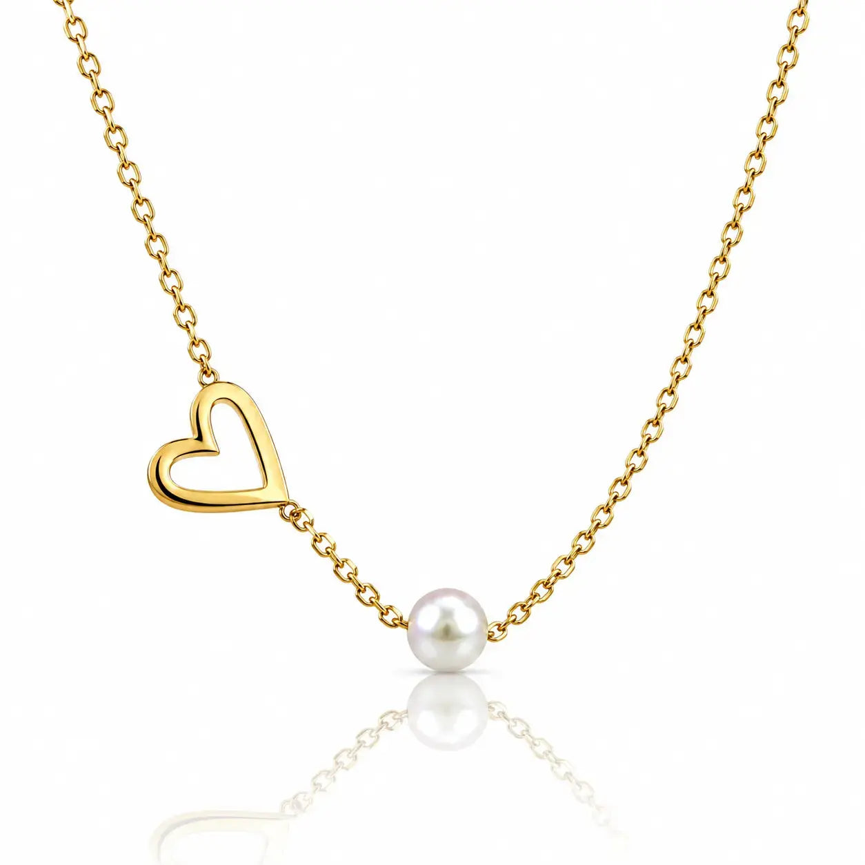 A delicate gold chain necklace featuring an open heart pendant and a single white pearl bead, displayed against a clean white background with a soft reflection below.