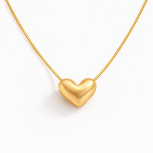 Gold heart-shaped pendant on a white background