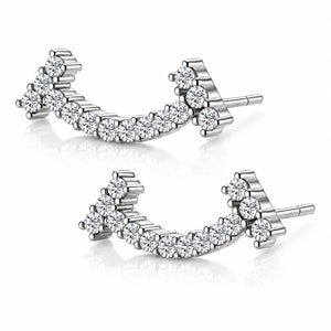 A pair of silver-toned curved stud earrings set with clear round-cut gemstones, displayed on a clean white background with soft reflections.