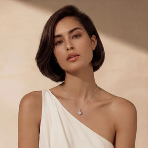 Woman wearing a necklace against a beige background