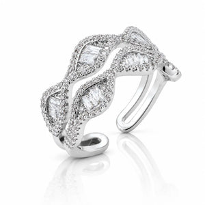 A silver-toned open cuff ring adorned with baguette and round-cut clear stones, shown on a clean white background with a soft reflection below.