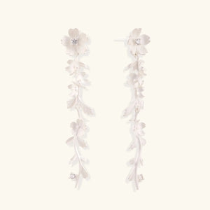 Sterling silver floral vine drop earrings with cascading flower design and matte finish on white background